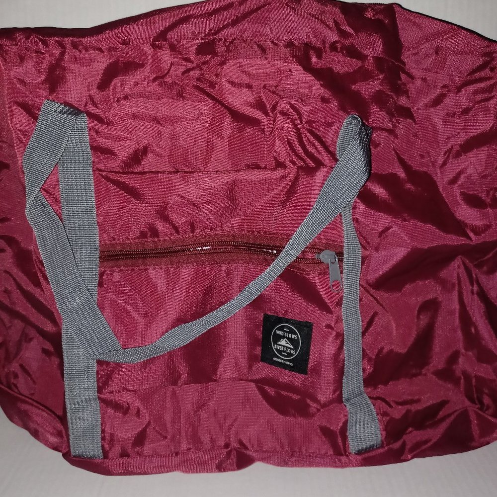 WIND BLOWS RIVER FLOWS TRAVEL BAG